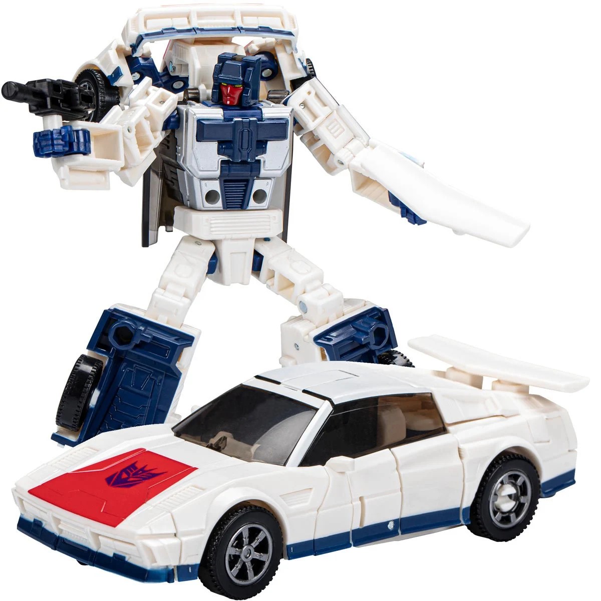 Transforming robot figure with a gun stands beside a white sports car, showcasing its dual form. Relevant for toy collectors and fans of the franchise.