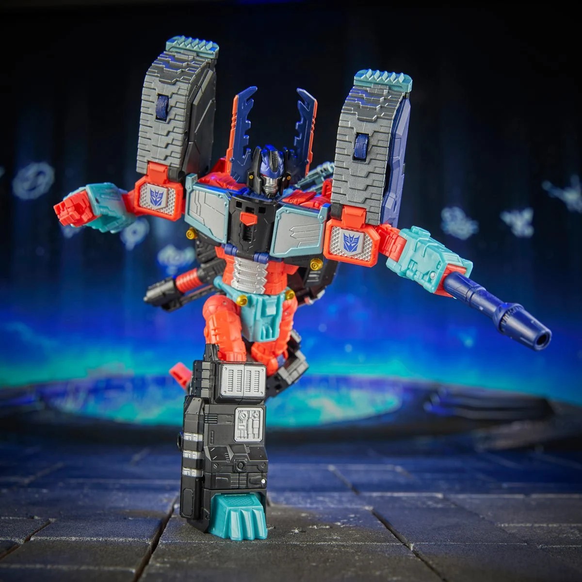 Transformers action figure prominently displayed, posing with outstretched arms and a weapon. The vibrant colors and details highlight its dynamic design.