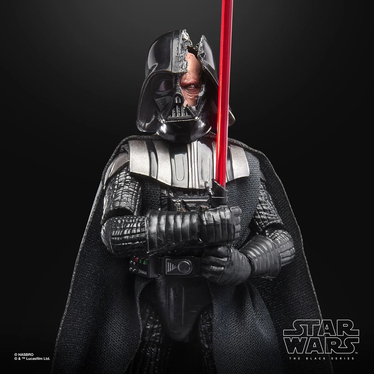 Darth Vader figure from Star Wars, wielding a red lightsaber, showcasing intricate detailing in armor and cape against a dark background.